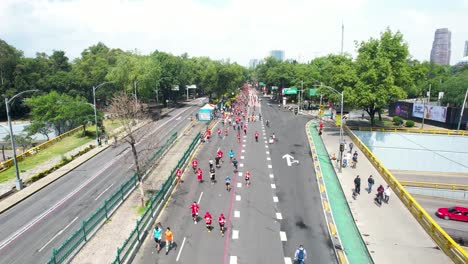 backwards-drone-shot-of-the-city-marathon-runners-as-they-pass-through-the-main-avenues-of-the-city