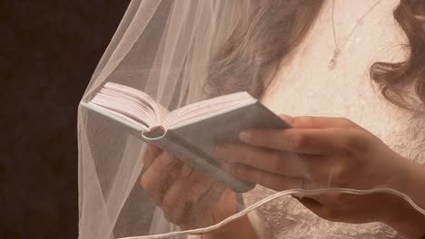 Jewish-woman-reading-scripture-under-her-vail