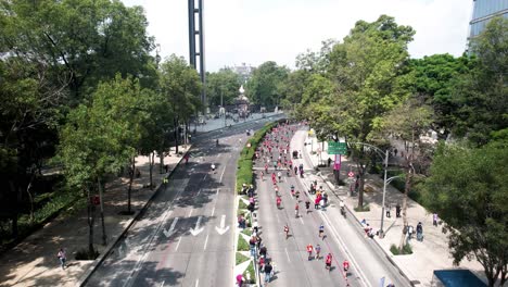 backwards-drone-shot-of-the-runners-of-the-city-marathon-as-it-passes-through-the-castle-of-chapultepec