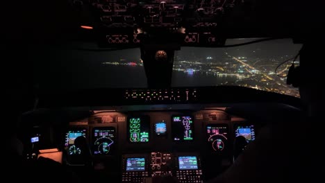 Exclusive-night-view-of-a-cockpit-jet-during-a-real-approach-to-the-airport-of-Ibiza,-Spain,-in-a-hazy-night