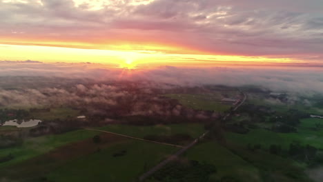 Drone-flying-high-above-fog-at-sunset