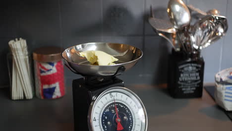 Weighing-butter-on-scales-for-cooking-and-baking-a-cake
