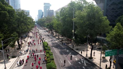 backwards-drone-shot-of-city-marathon-runners-as-they-pass-through-the-city-downtown