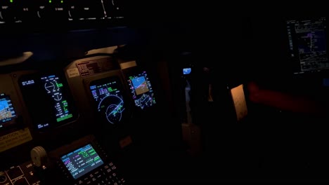 Exclusive-night-view-of-a-jet-cockpit-controls-and-flight-instruments-during-a-right-turn