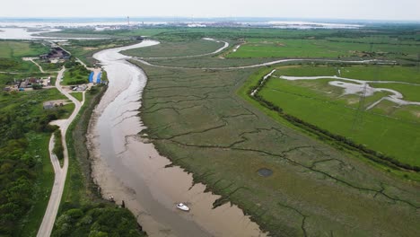 Aerial-view-flying-across-Wat-Tyler-eroded-marshland-following-muddy-riverbed