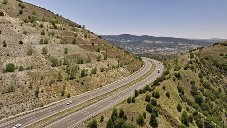 Ankara-Province-Turkey-Aerial-v4-cinematic-low-level-drone-flyover-kuşcuören-hillside-highway-with-vehicles-driving-on-salient-curve-road-with-rural-landscape-view---Shot-with-Mavic-3-Cine---July-2022