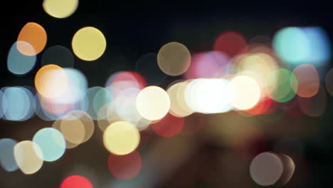 Night-road-lights-blurred-bokeh-of-cars-in-traffic-on-the-road-at-night