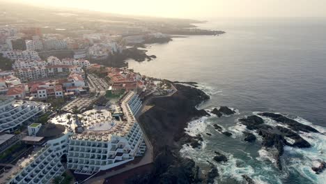 Dron-shot-of-big-houses-inacoast-line-andbig-waves-around-in-Canary-Island,-Spain