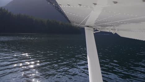 Seaplane-Takeoff-From-Natural-Lake,-Passenger-View-of-Wing-and-Strut