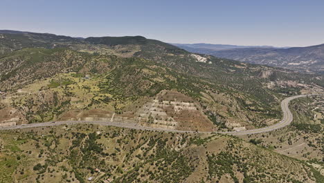 Ankara-Province-Turkey-Aerial-v2-cinematic-panning-view-capturing-thrilling-curvature-of-hillside-highway-route-at-remote-kuşcuören-and-yakakaya-village-area---Shot-with-Mavic-3-Cine---July-2022