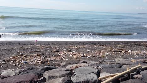 Beach-Full-of-Trash-in-East-Bali,-Indonesia-Ketewel,-Keramas,-Denpasar-Sea-Coast,-Polluted-with-plastic-and-wood-buried-in-the-sand