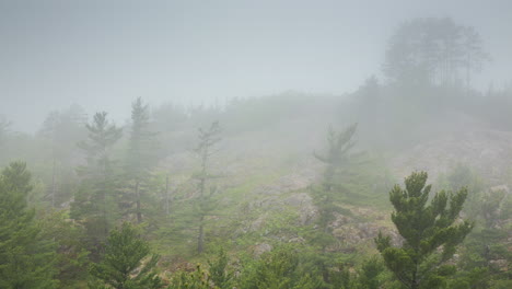 Time-lapse-of-fog-and-clouds-swirling-around-the-rugged-and-rocky-hills-of-northern-Michigan