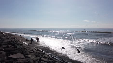 Kinder-Baden-Im-Wilden-Meer,-Bali-Indonesien-Wasserreflexion,-Sonne-Und-Klarer-Tag,-Wogender-Ozean-In-Ketewel,-Gianyar,-60-Fps