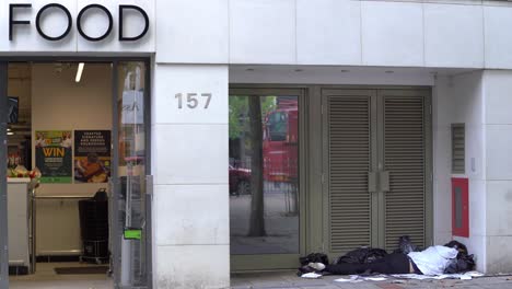 A-homeless-person-sleeping-in-a-high-street-doorway-in-Wanstead,-London