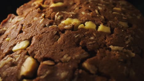 Close-up-biscuits-surface-with-brown-baked-chocolate-and-nuts