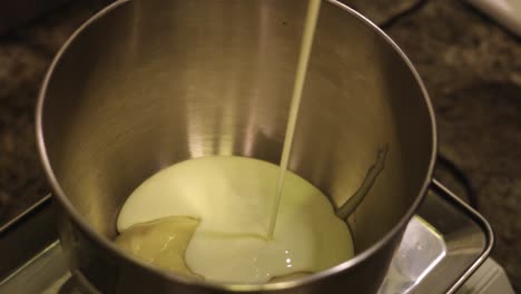 Milk-is-added-to-the-pot-to-prepare-the-dough-needed-for-pastry