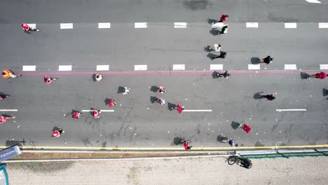 aerial-drone-shot-of-the-city-marathon-runners-as-they-pass-through-the-large-avenues