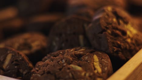 Cookies-with-chocolate-chips-and-nuts-on-wooden-table,-close-up-macro-shot