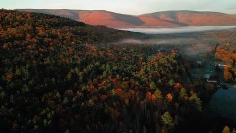 Aerial-view-of-temperature-inversion-over-Catskills---treetops-with-pretty-fall-foliage-leaves-and-glowing-mountains