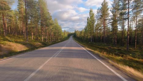 Golden-hour-driving-POV:-Driving-on-highway-through-boreal-forest