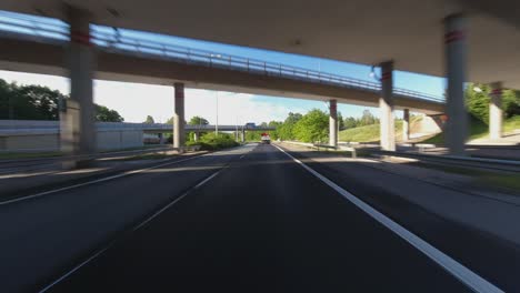 Drive-POV:-Following-truck-through-overpasses-on-sunny-highway-commute