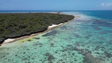 Coral-filled-reef-lagoon-in-Pungume-Island-Tanzania-Africa-southern-Zanzibar-Isle,-Aerial-flyover-shot