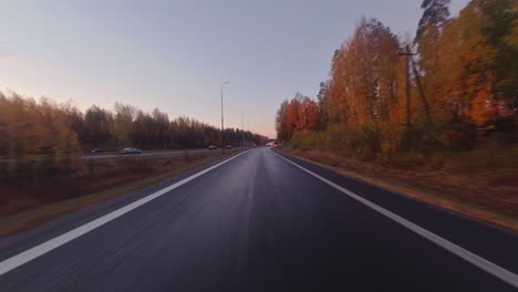 POV:-Driving-on-highway-entrance-ramp-through-colorful-autumn-trees