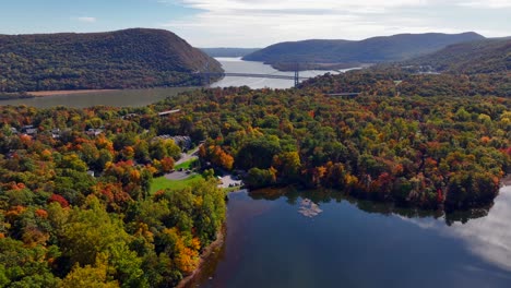 An-aerial-view-of-a-reflective-lake-with-colorful-trees-in-upstate-NY