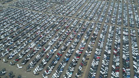 Many-cars-on-a-parking-lot-from-above,-filmed-with-a-drone-in-4k