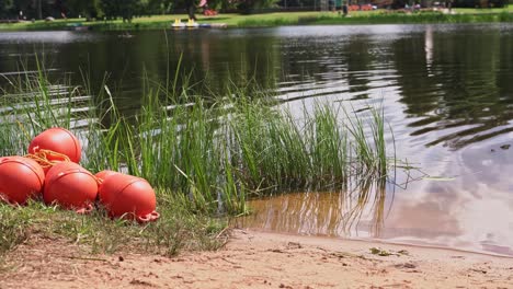 Orange-buoys-next-to-the-swimming-area,-water-safety-on-the-lake