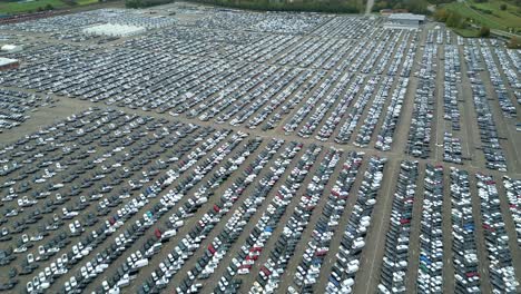 Many-cars-on-a-parking-lot-from-top,-filmed-with-a-drone-in-4k