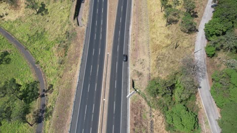 Timelapse-from-aereal-view-with-drone-following-a-car-in-a-freeway-in-Escuintla-Guatemala