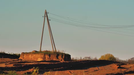 Power-lines-with-sun-rays-on-blue-sky