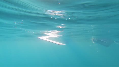 Underwater-lurking-point-of-view-watching-rowing-oars-paddling-through-water