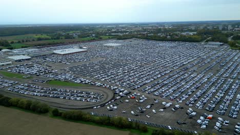 Many-cars-on-a-parking-lot-from-above,-filmed-with-a-drone-in-4k,-parked-cars