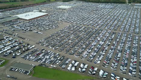 Many-cars-on-a-parking-lot-from-above,-filmed-with-a-drone-in-4k