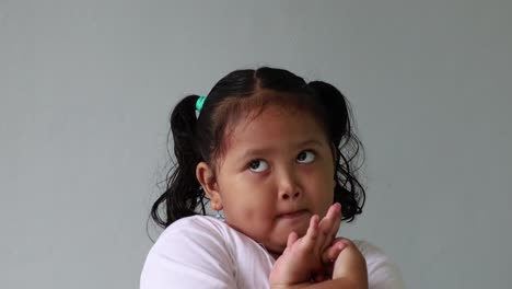 Medium-shot-of-asian-little-girl-with-any-expression