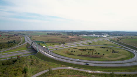 Aerial-view-above-Straszyn-large-curving-highway-infrastructure-with-busy-traffic,-Gdansk