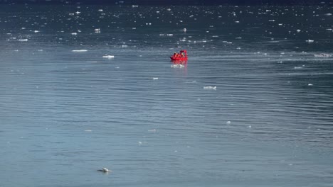 Red-boat-floats-on-glacial-waters-in-Glacier-Bay-National-Park-in-Alaska