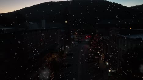 Snowflakes-fall-at-mountain-ski-resort-town-at-night