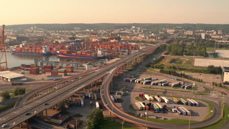 Aerial-view-long-straight-highway-468-alongside-Awanport-seaport,-Gdynia,-Poland