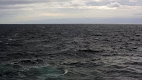 View-from-ship-of-dark,-rough,-cloudy-Sea-between-Prince-Edward-Island-and-La-Baie,-Saguenay