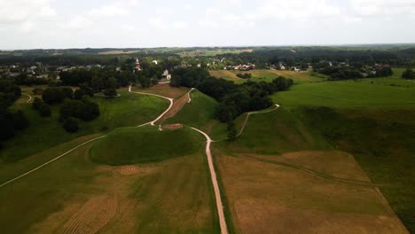 A-drone-footage-of-lush-green-fields-and-trees-in-Kernave-mounds-in-Lithuania