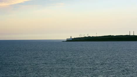 Coastal-Lighthouse-with-windmills-near-Sydney,-Nova-Scotia-off-Cape-Breton-Island