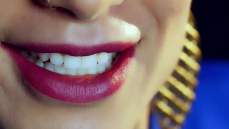 Woman's-smile-with-red-lipstick-and-nose-piercing,-close-up