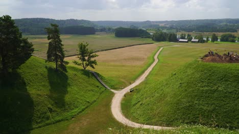 An-aerial-view-of-the-rural-Kernave-Mounds-in-the-countryside-of-Kernave,-Lithuania