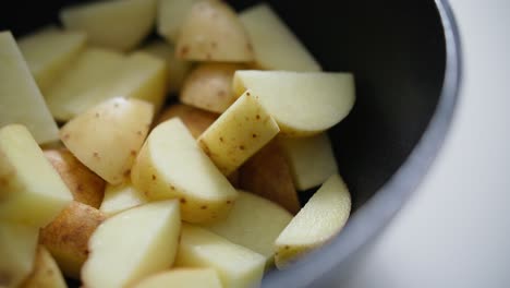 Chopped-potatoes-being-thrown-into-a-pan