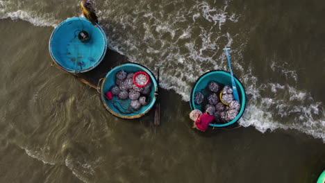 Aerial-top-down,-traditional-Vietnamese-round-coracle-boats-on-beach-shore