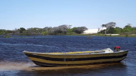fishing-boat-moored-at-lake-on-tropical-wetland-scenery,-static-shot