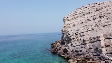 Drone-shot-of-rocky-mountain-beach-in-Oman